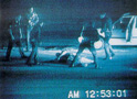 Video still of Rodney King being beaten by police