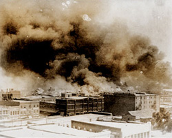 The African-American district burns during the Tulsa race riots of May, 1921. 